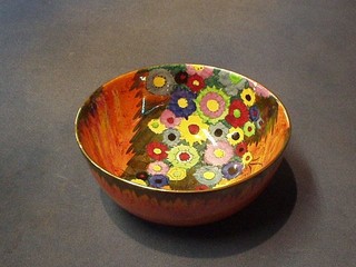 A Carltonware orange glazed pottery bowl, the interior with floral decoration, 7"