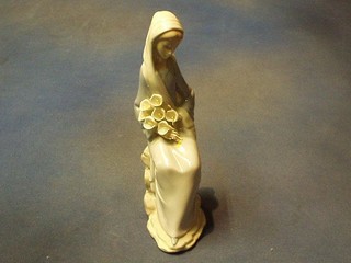 A Lladro figure of a seated girl with lilys, the base incised 5, 9"