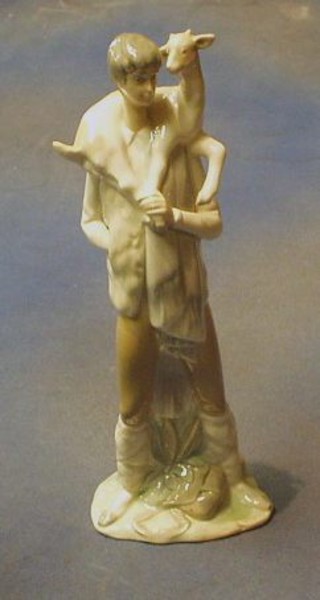 A Lladro figure of a boy carrying a goat, the base impressed D30 11 1/2"