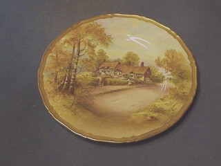 A Royal Worcester porcelain plate, painted Anne Hathaway's Cottage, the reverse impressed 3Q1W and with black Royal Worcester mark, 11"