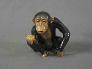 A seated figure of a monkey with banana 7"
