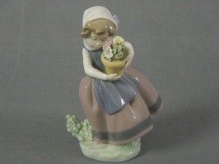 A Lladro figure of a girl with pot plant, base marked Lladro and incised 5-5B1 7"
