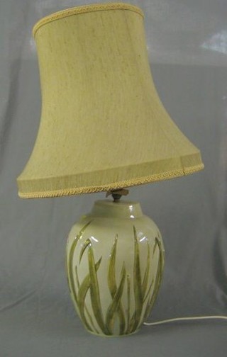 A globular shaped pottery  table lamp decorated reeds 15"