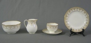 A  31 piece Wedgwood white glazed tea service with gilt banding and swags, the base marked W778 comprising 2 twin handled bread plates, cream jug, sugar bowl, 12 7" tea plates, 6 saucers, 6 cups
