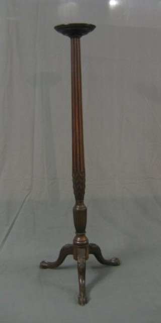A 19th Century turned and reeded mahogany torchere raised on tripod support with egg and claw feet