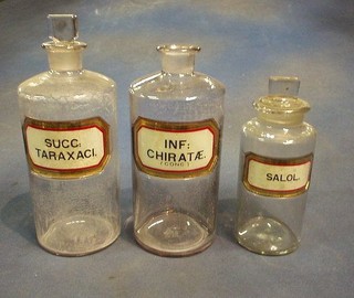 3 19th/20th Century clear glass chemists jars marked Succ.Taraxaic with stopper, INF.Chiratae (CONC) no stopper, and Saloa with stopper