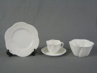 A 19 piece Shelley white glazed tea service comprising 5 cups (1 cracked) 6 saucers (1 cracked), 6 tea plates, twin handled bread plate, the base marked Shelley England RD no. 735121