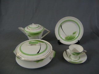 A 46 piece Art Deco Palissy dinner/tea service comprising 3 oval pottery meat plates (some crazing), 2 tureens and covers, 6 10" dinner plates (some crazing), 6 9" side plates (crazing), 6 8" tea plates (1 cracked), square bread plated, tea pot, cream jug and sugar bowl, sauce boat, 6 square tea plates (2 cracked), 6 saucers (1 cracked), 6 tea cups, all decorated stylised trees and birds with black and gilt banding