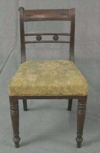 A set of 4 Regency mahogany bar back dining chairs with pierced mid rail and upholstered seat on ring turned supports