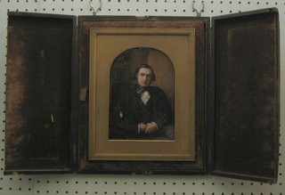 A 19th Century portrait miniature "Seated Gentleman in Library" 7" x 5" oval, contained in a leather case