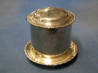 A circular silver plated biscuit tin with hinged lid and bead work border, raised on bun feet 5"