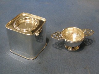 A modern square silver plated tea caddy marked Harrods and a silver plated tea strainer and stand