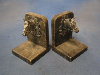 A handsome pair of silver plated and marble book ends decorated reeded horses heads