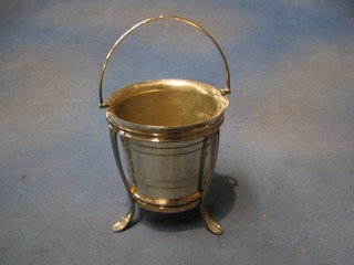 A  silver plated ice pail with swing handle 4" and a circular silver plated stand raised on 3 feet