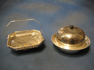 A circular silver plated muffin dish and cover and an octagonal shaped pierced silver plated cake basket with swing handle