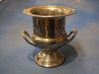 A circular silver plated twin handled wine cooler raised on a spreading foot 10"