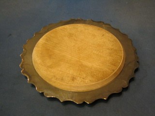 A circular silver plated bread board holder 11"