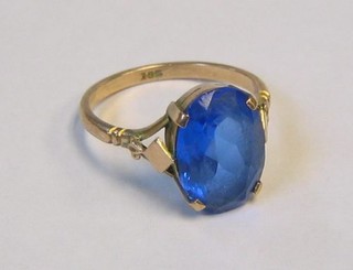 A 9ct gold dress ring set an oval cut blue stone