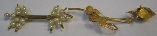 A gilt metal brooch in the form of a flower head and a do. decorated pearls (2)