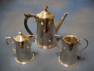 A 3 piece coffee service of tapering cylindrical form with coffee pot, twin handled sugar bowl and cream jug