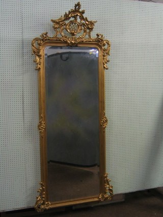 A 19th Century arched plate mirror contained in a decorative gilt frame with acanthus leaf decoration