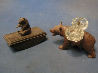 A Swiss carved wooden desk blotter decorated a bear 4", a matching salt with cut glass paniers, 3 other Swiss figures of bears, a carved figure of a St Bernard and 1 other dog