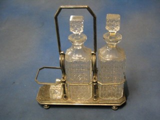 A silver plated 3 bottle decanter stand with 2 cut glass decanters