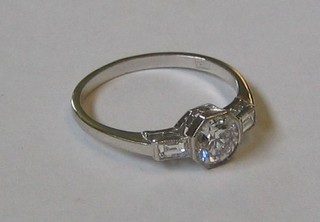 A lady's 18ct white gold dress ring set a diamond with baguette cut diamonds to the shoulders (approx 0.63/0.11ct)