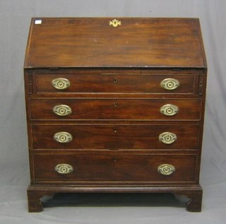 A Georgian mahogany bureau, the fall front with cross banding and revealing a well fitted interior, above 4 long drawers, raised on bracket feet 37"