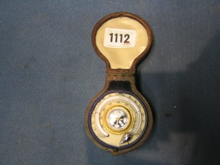A 19th Century travelling thermometer with compass contained in a leather carrying case