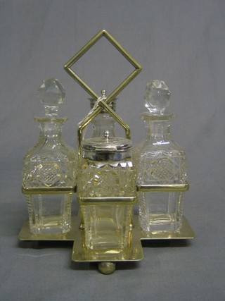 A silver plated 4 bottle condiment set with cut glass bottles