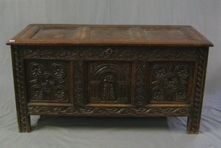 A 17th/18th Century carved oak coffer of panel construction with hinged lid 53"