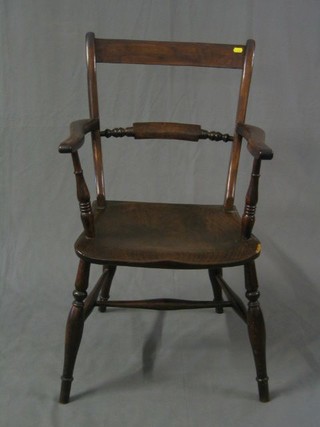 A 19th Century elm bar back carver chair with solid elm seat on turned supports united by an H framed stretcher