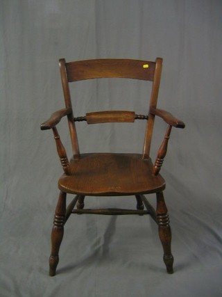 An elm open arm carver chair with solid elm seat and turned supports united by an H framed stretcher