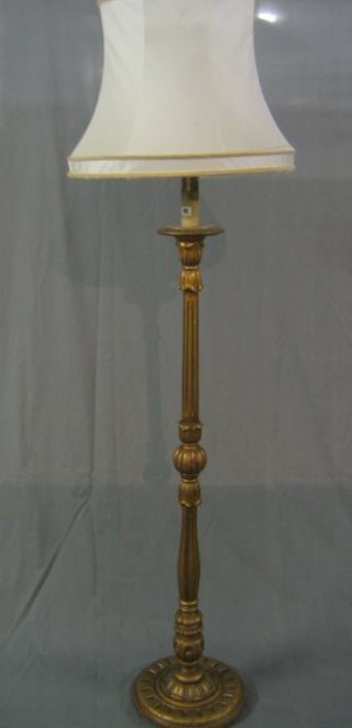 A gilt painted turned and fluted standard lamp