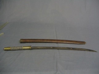 An Eastern dagger with crescent shaped blade contained in a wooden scabbard with fish skin grip  28"