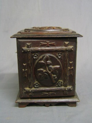 An oak smoker's cabinet enclosed by a carved oak panelled door, 10", raised on bracket feet