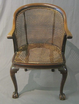 A 19th Century walnutwood tub back library chair with woven cane seat and back, on cabriole supports