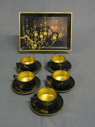 An Oriental lacquered 6 piece coffee set comprising tray, 5 cups and saucers