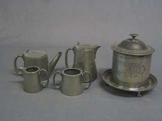 A Victorian circular engraved pewter biscuit barrel with hinged lid  and  a planished English pewter 4 piece tea service