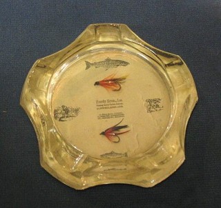 A Hardy Bros circular glass ashtray with back paper decorated fish set 2 hooks with flies, marked Hardy Bros London 61 Palmall, 14 Moulton St. Manchester and 101 Princes St Edinburgh, 3"