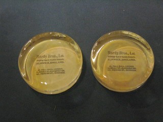 2 Hardy Bros circular advertising glass paperweights marked Hardy Bros Ltd Fishing Rods and Tackle Makers, Alnwick England 61 Palmall, 41 Moulton St Manchester and 101 Princes St. Edinburgh 3"