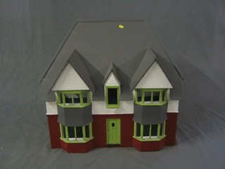 A child's substantial dolls house in the form of a 1930's detached house 30"