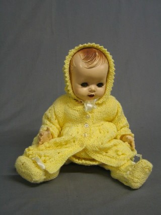 A Pedigree baby doll wearing yellow knitted clothes