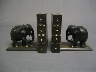 A pair of ebony and ivory book ends in the form of standing elephants
