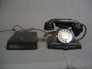 A 1950's black Bakelite dial telephone complete with bell box