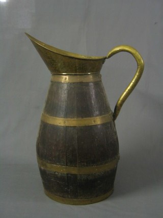 A large old coopered jug with brass spout 23"