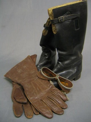 A pair of WWII flying boots, a pair of brown leather gauntlets and a pair of tinted goggles