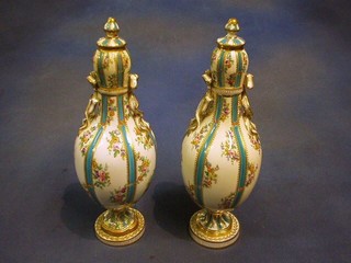 A pair of 19th Century Continental club shaped urns and covers with turquoise and gilt banding and floral decoration 12" (f and r)