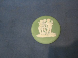 A 19th Century circular Wedgwood green Jasperware plaque decorated cherub playing a lyre and with 2 other cherubs, base marked Wedgwood, 4"